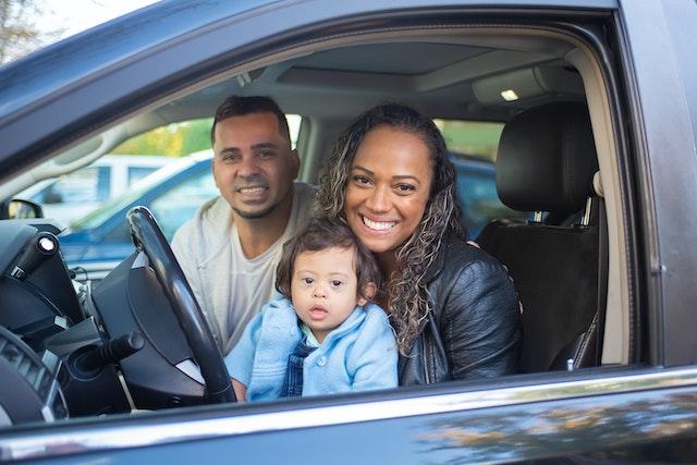 Image of a Family Sat in a New Car