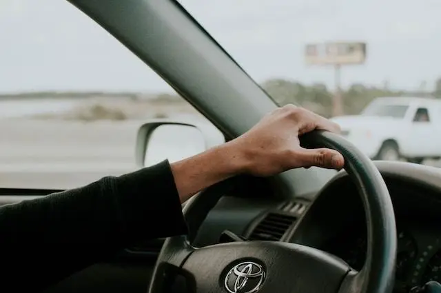 Man holding a Car Steering Wheel