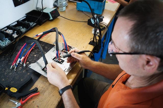 Image of a Man working on a Car Wiring Loom