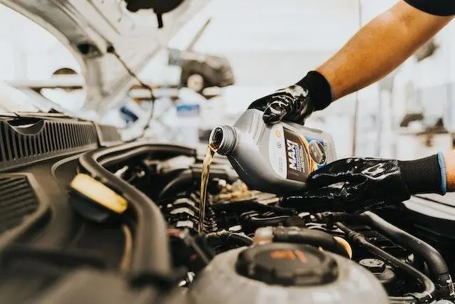 Pouring Oil into a Car Engine