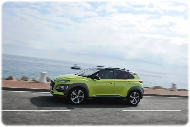 2018 Hyundai Kona in Acid Yellow driving along a coastal road