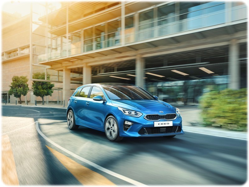 The new 2018 Kia Ceed driving through a city, front view