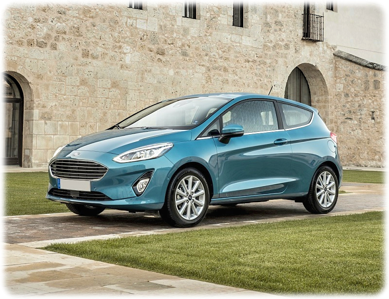 Top 5 New Cars February 2018, The Ford Fiesta, static picture of the new Fiesta in a courtyard around green grass and a stone wall