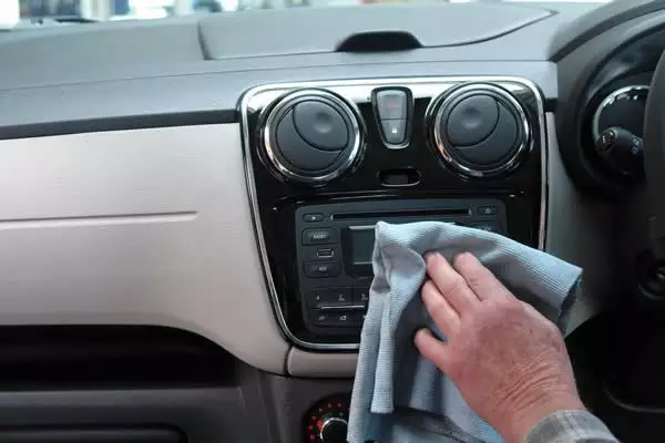 person cleaning inside of car