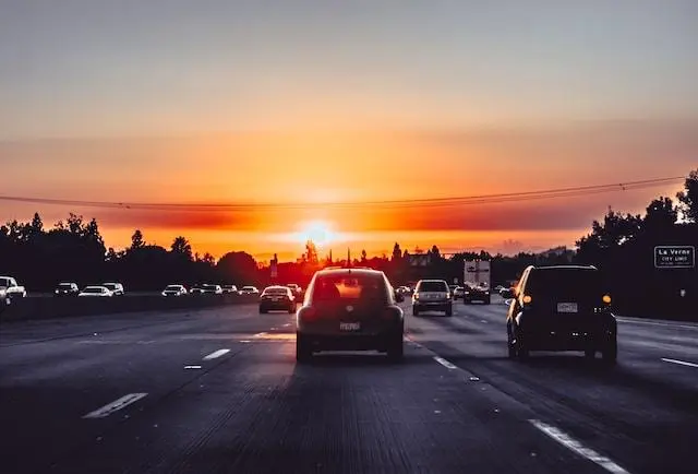 Image of a Car Driving into the Sunset