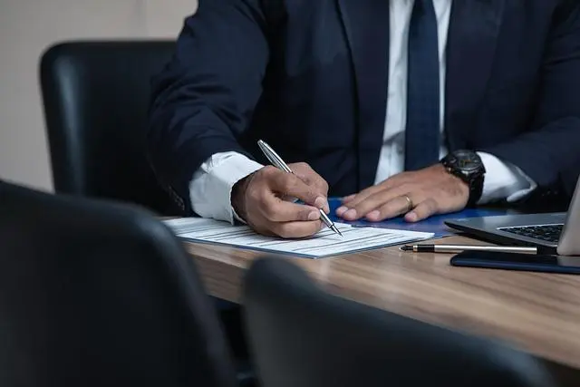 Image of a Man Signing a Warranty Document