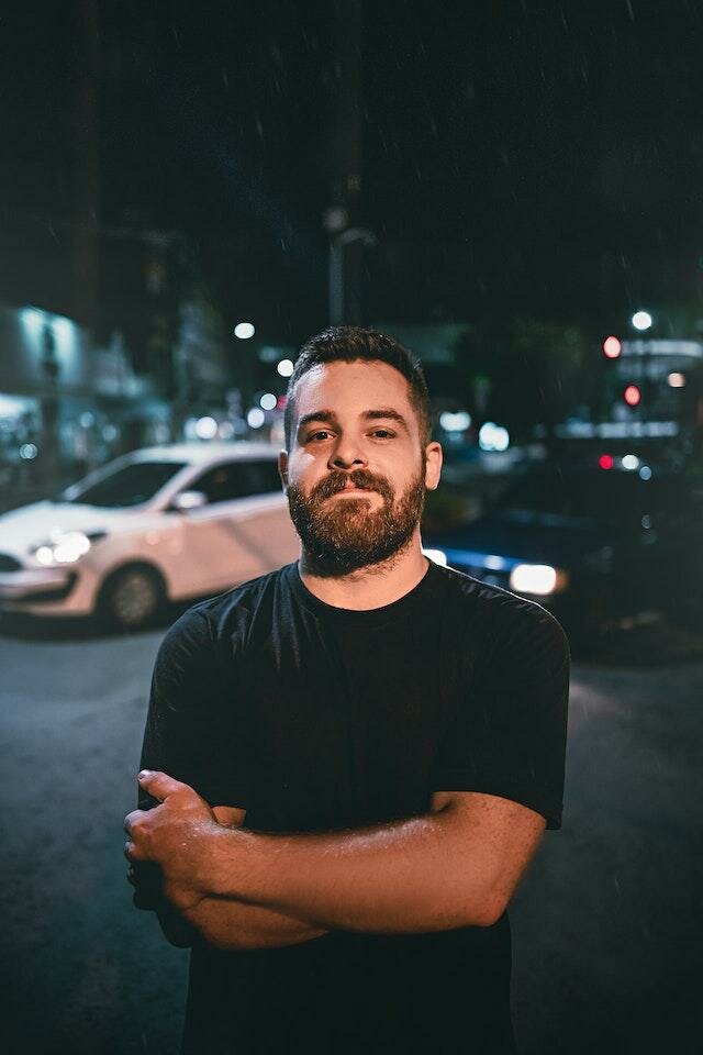 Image of a Man stood in front of a Car