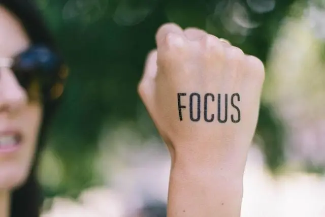 Image of the word Focus Written on a Ladys Hand