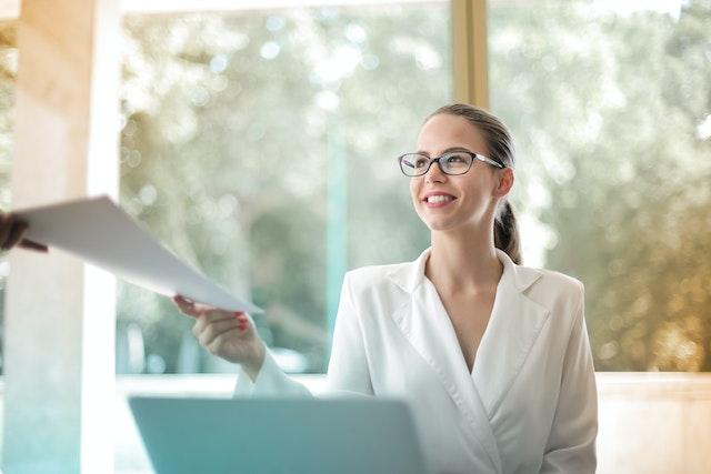 Image of a Lady Handing Over Paperwork