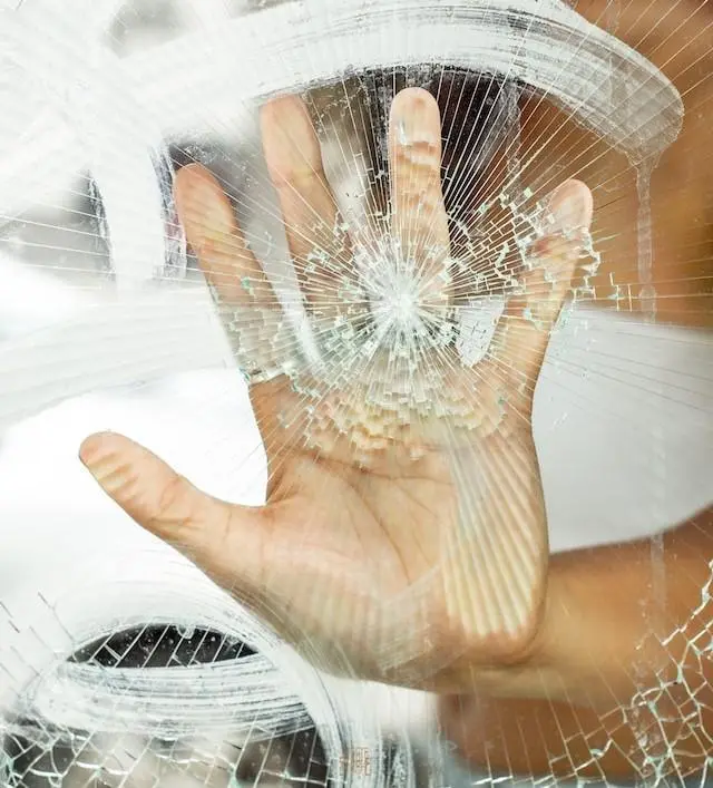 Drivers hand on a Broken Windscreen