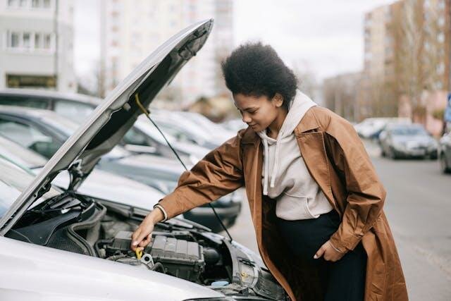 Lady Checking the Oil Level on her Car